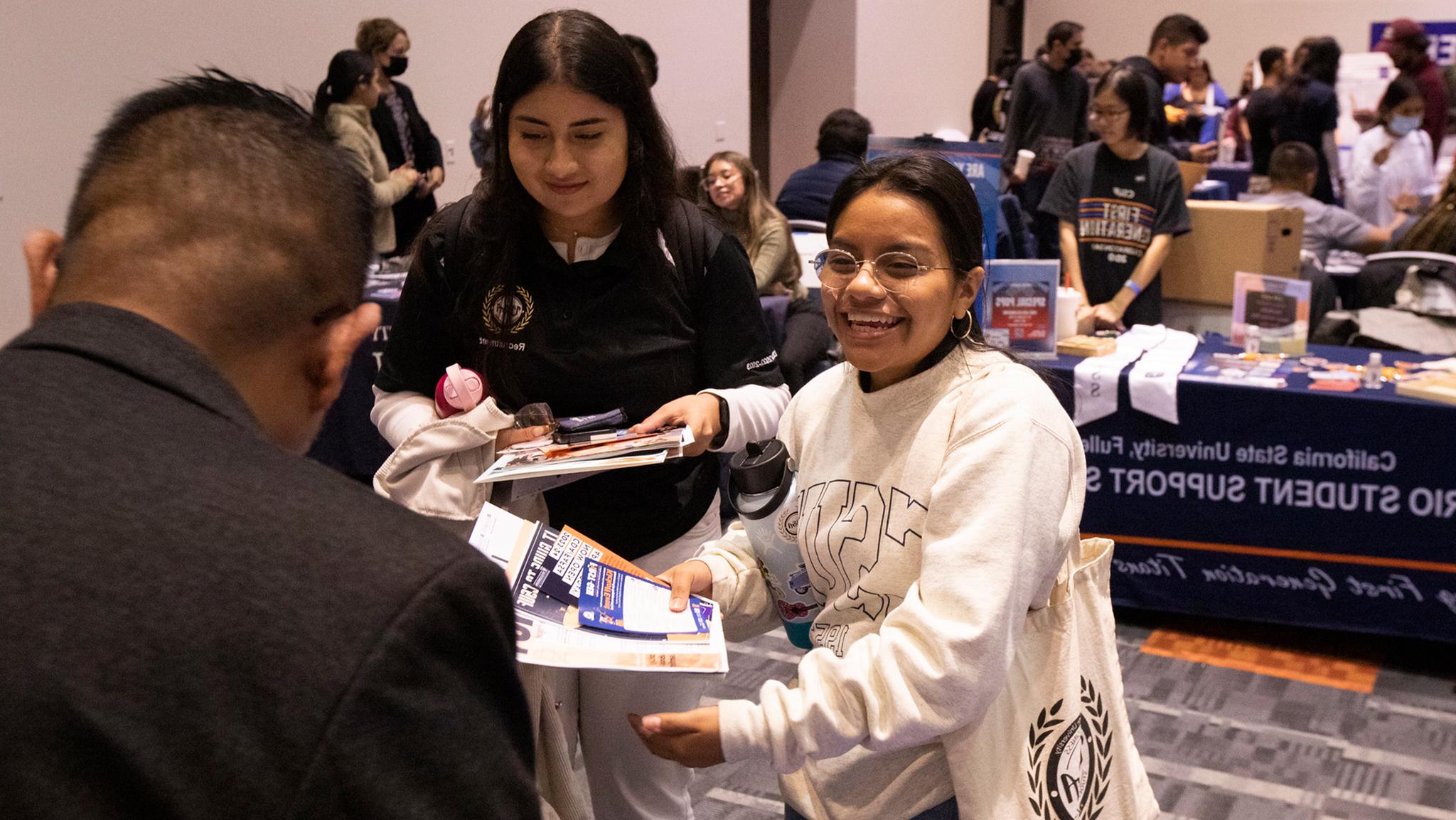 Student smiling at first-gen resource fair